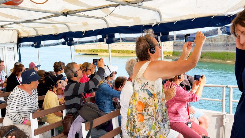Passengers on board the Archimède photographing the Mulberry harbour caissons.