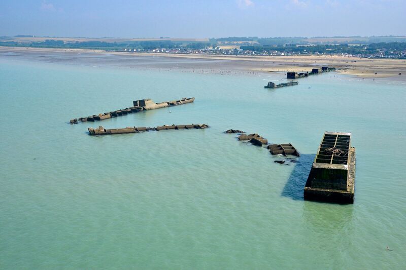 Phoenix caisson seen from the Arromanches coast, line of remains of the Allied artificial harbour.